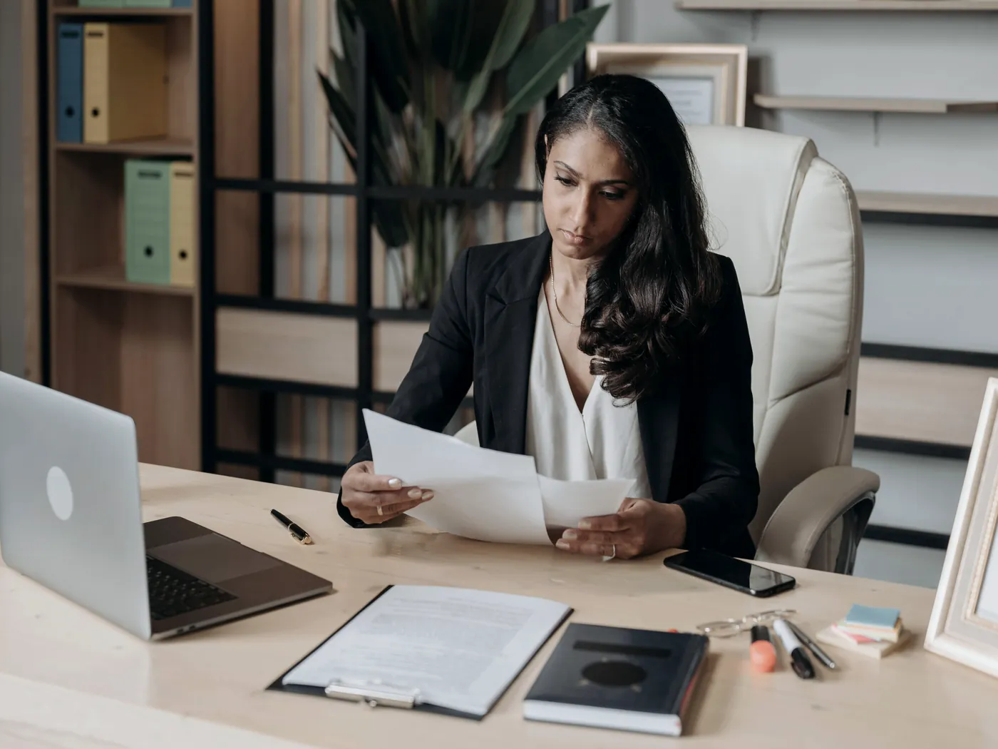 Lawyer reviewing a client file at her desk